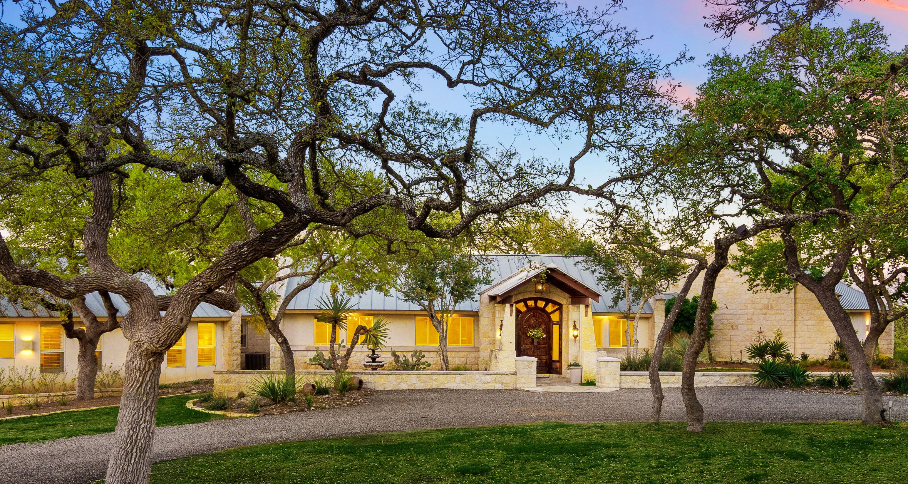 Beautiful countryside retreat with charming trees and rustic architecture at dusk near Austin