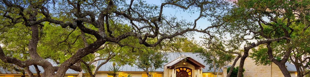 Beautiful countryside retreat with charming trees and rustic architecture at dusk near Austin