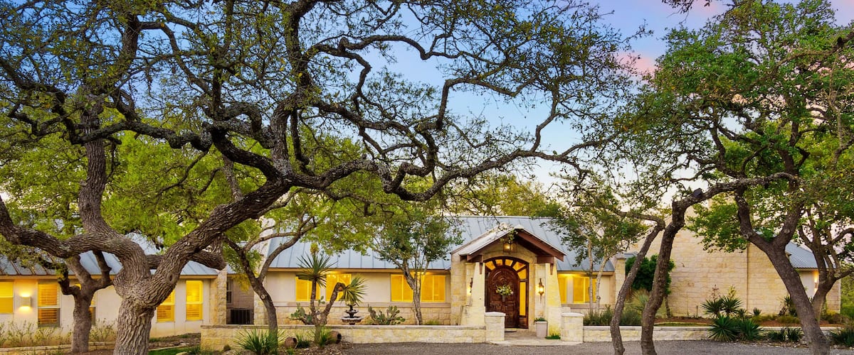 Beautiful countryside retreat with charming trees and rustic architecture at dusk near Austin