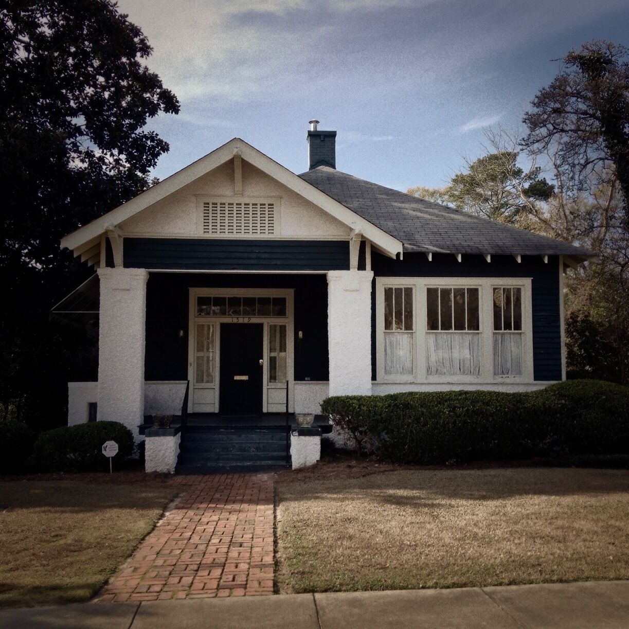 The family of author Carson McCullers moved to this house in 1927. Here Lula Carson Smith spent her formative years 10-17 and here she began to write, putting on shows in the two sitting rooms, using the sliding doors as curtains and drafting brother Lamar and sister Rita as actors. Shows grew into plays, stories and novels. She left to study writing in New York in 1934. When a teacher told her that the best stories can be found in one's own back yard, her "green arcade" of trees drew her home again. In the summer of 1935 she met James Reeves McCullers, Jr., whom she married in the garden here in Sept., 1937. They moved to North Carolina where the young author completed her first novel The Heart is a Lonely Hunter. During World War II, with Reeves overseas, Carson lived in New York but often returned home to work and rest. She liked to sit in the kitchen, absorbing its warmth, the aroma of food cooking and the conversation of the cook. In her front bedroom she kept her piano and the typewriter where she worked on her novel, and later prize winning-play, The Member of the Wedding. After the death of her father in 1944, Carson and her mother made their home in Nyack, N.Y.