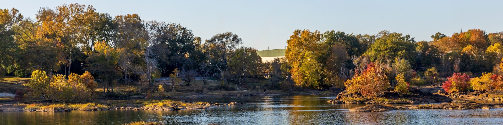 A river with rocks and trees with autumn foliage.