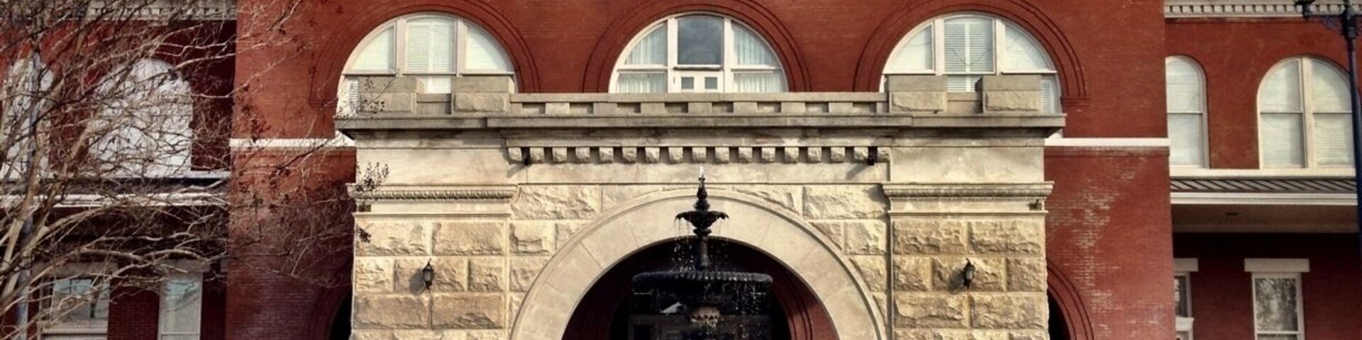 The Central of Georgia Railroad's Station, designed by Bruce and Morgan of Atlanta, GA, was erected in 1901. Featuring massive granite arches, it served as the transportation hub of the city for over 70 years. Threatened with demolition in 1984, this landmark, on the eastern perimeter of the Original City, was saved through the leadership of the Historic Columbus Foundation and the generosity of the Southern Railway System and the Consolidated Government of Columbus and its citizens. The property was listed on the National Register of Historic Places in 1980.