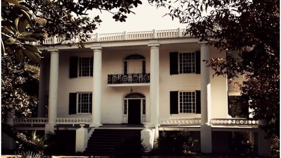 "St. Elmo", one of the most exquisite examples of the classic houses in America, stands in view of this point, it was built on the old Stagecoach Road by Colonel Seaborn Jones, for his wife, Mary Howard Jones. Completed in 1833, it was originally called "El Dorado." Here, Augusta Jane Evans visited her aunt and found inspiration for her celebrated novel "St. Elmo."
As a member of Governor Troup's staff, Seaborn Jones came to the site of Columbus with LaFayette in 1825. Lawyer, painter, solicitor-general of the Ocmulgee Circuit (1817-1818), he was member of Congress in 1835-45- 47. President James K. Polk, President Millard Fillmore, Henry Clay, and General Winfield Scott were distinguished visitors entertained in this house by Colonel Jones.
In 1878, the place became the home of Captain and Mrs. James J. Slade and the name changed to St. Elmo. Captain Slade once conducted a girls school here.