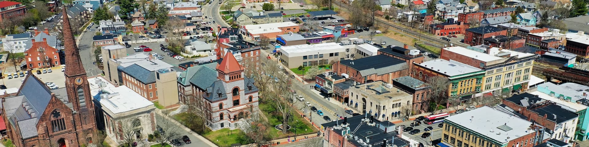 A town with historic buildings, a prominent church, and a railway line.