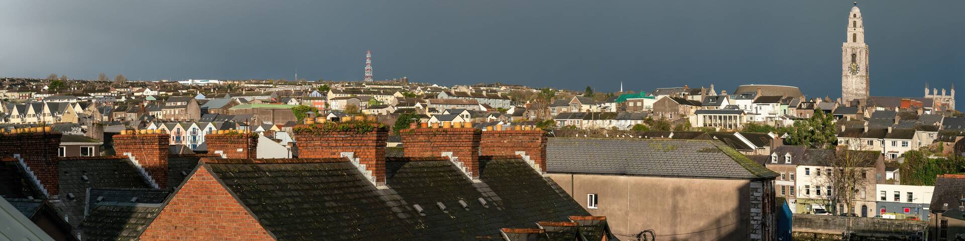 A coastal town with a prominent tower and a lighthouse.