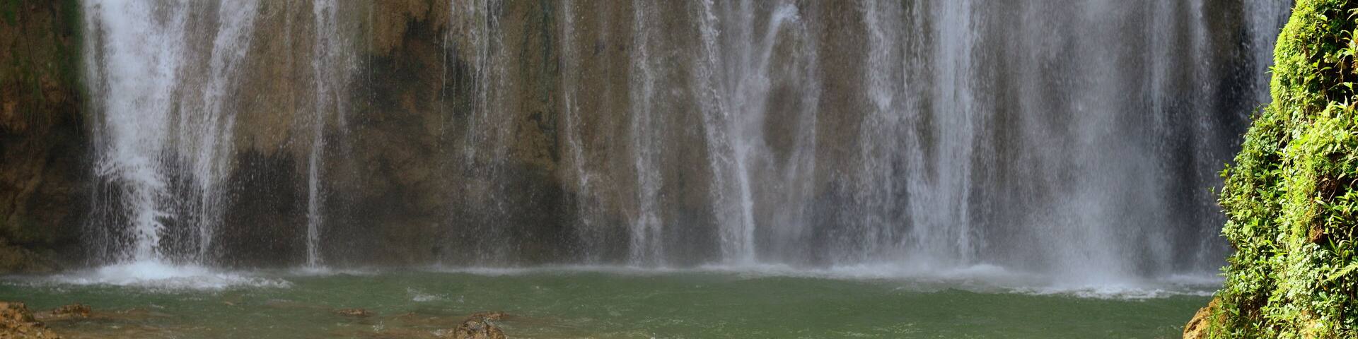 Tourist swimming in the Salto el Limon the waterfall located in the centre of the tropical forest, Samana, Dominikana Republic.