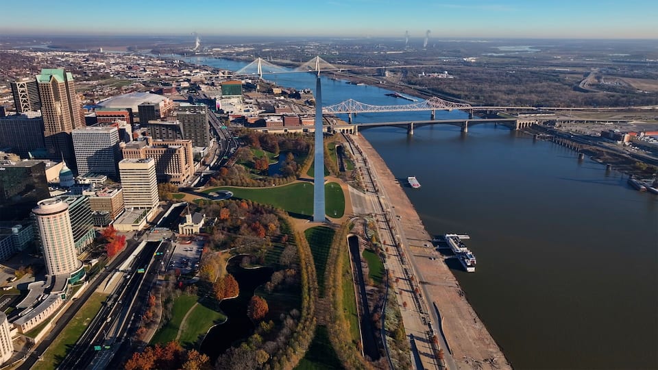 Aerial view of the iconic Gateway Arch and Mississippi River with urban skyline and bridges, Downtown St. Louis, Missouri, United States.
