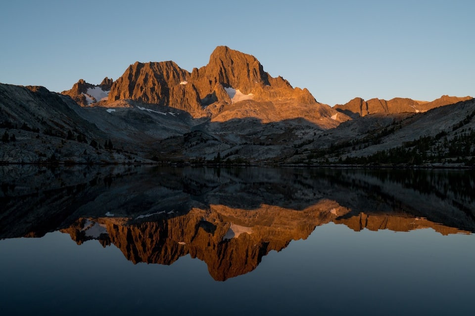 A mountain range with a lake reflecting the peaks.