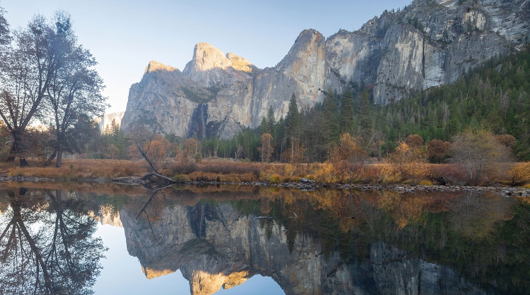 Cathedral Rocks reflecting on Merced River at autumn sunset via Valley View. Yosemite National Park, California, USA.