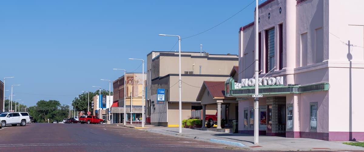A street with buildings, including a theater named 'NORTON'.