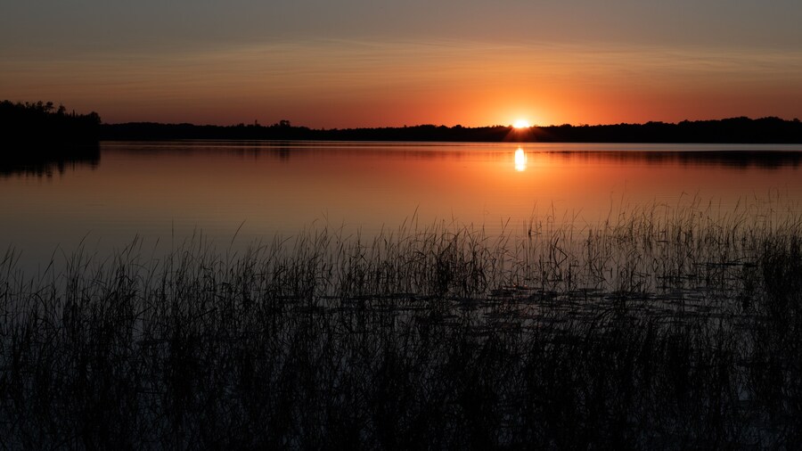 Beautiful sunset on northern lake with reflection