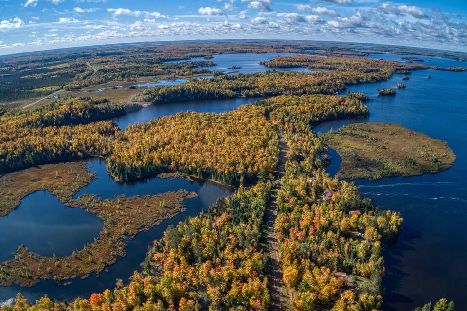 A river winding through a forest with autumn foliage.