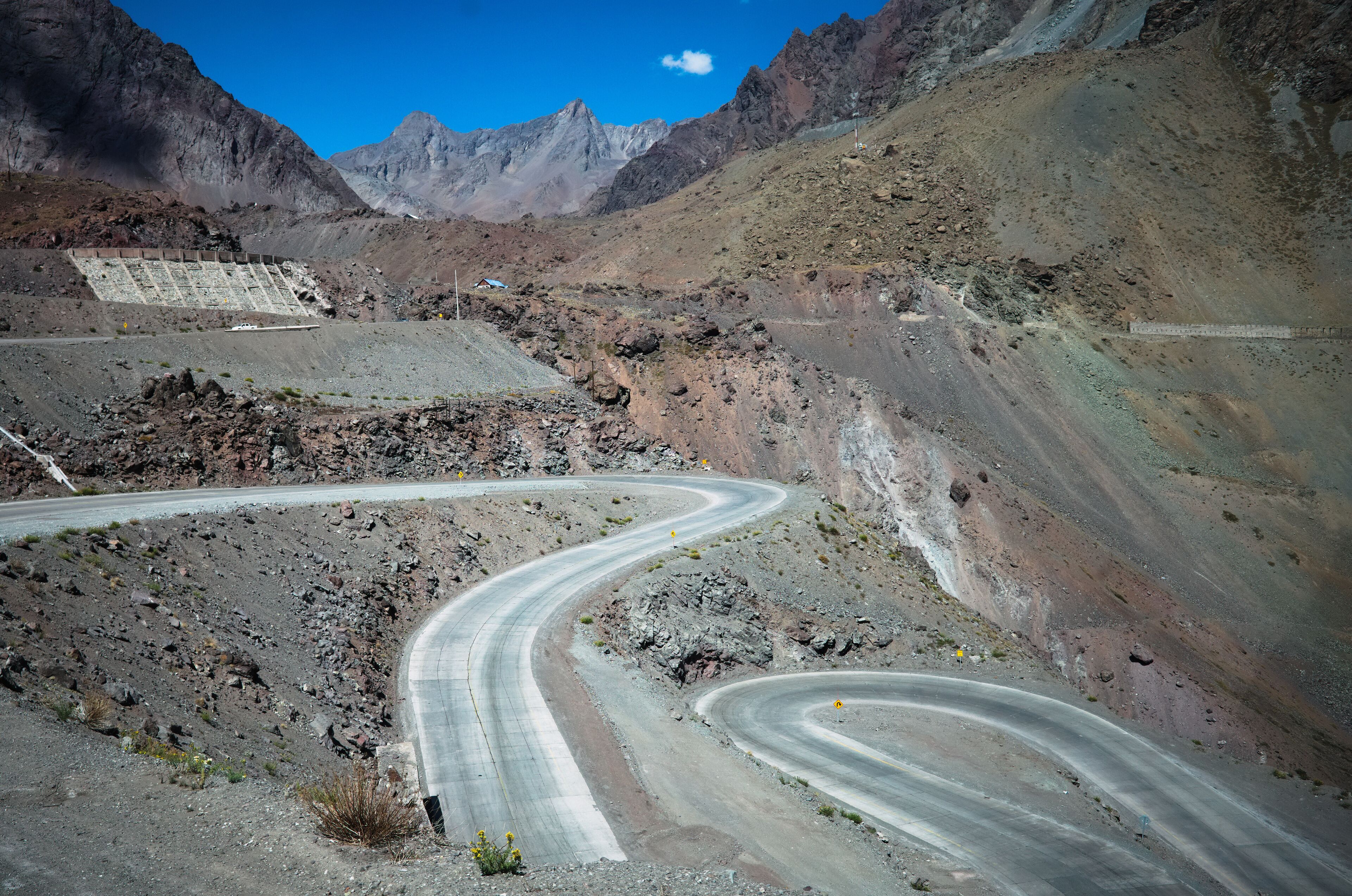 Winding road in Andes Mountains near Argentina Chile border. Serpentine road Caracoles Juncal, near valley of Río Juncalillo. Los Andes, Chile