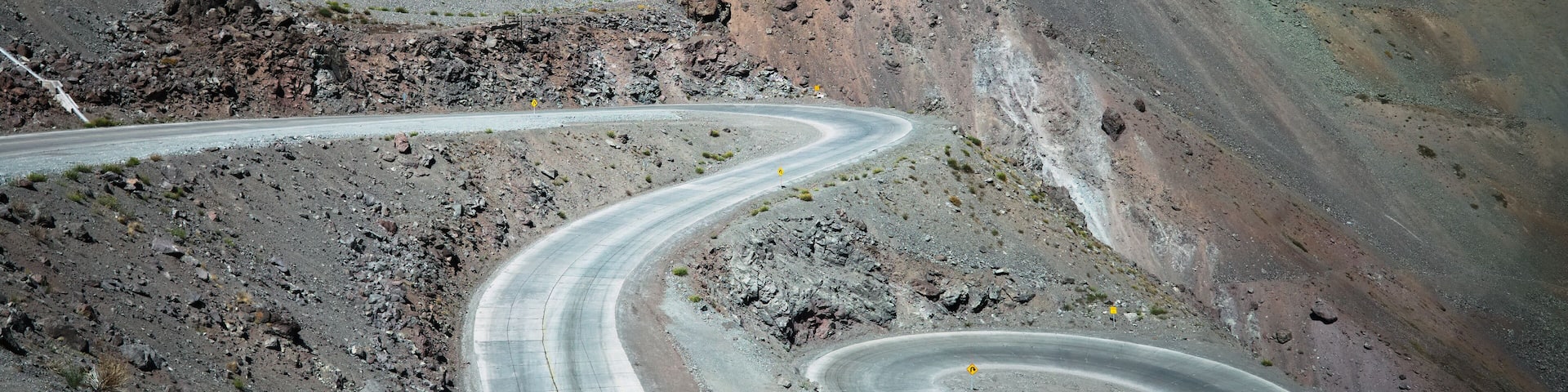Winding road in Andes Mountains near Argentina Chile border. Serpentine road Caracoles Juncal, near valley of Río Juncalillo. Los Andes, Chile