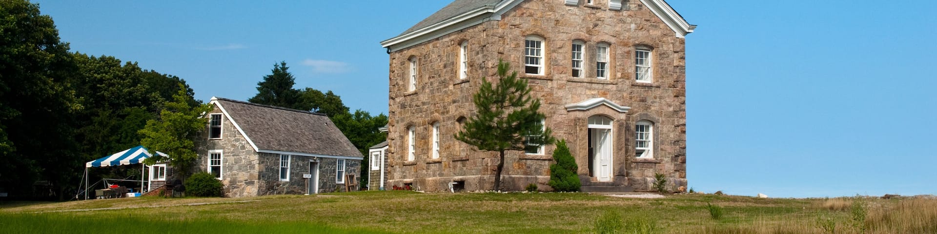 Sheffield Island lighthouse on a summer day in Connecticut. It is located on one of the Norwalk islands and hosts many events for tourists.