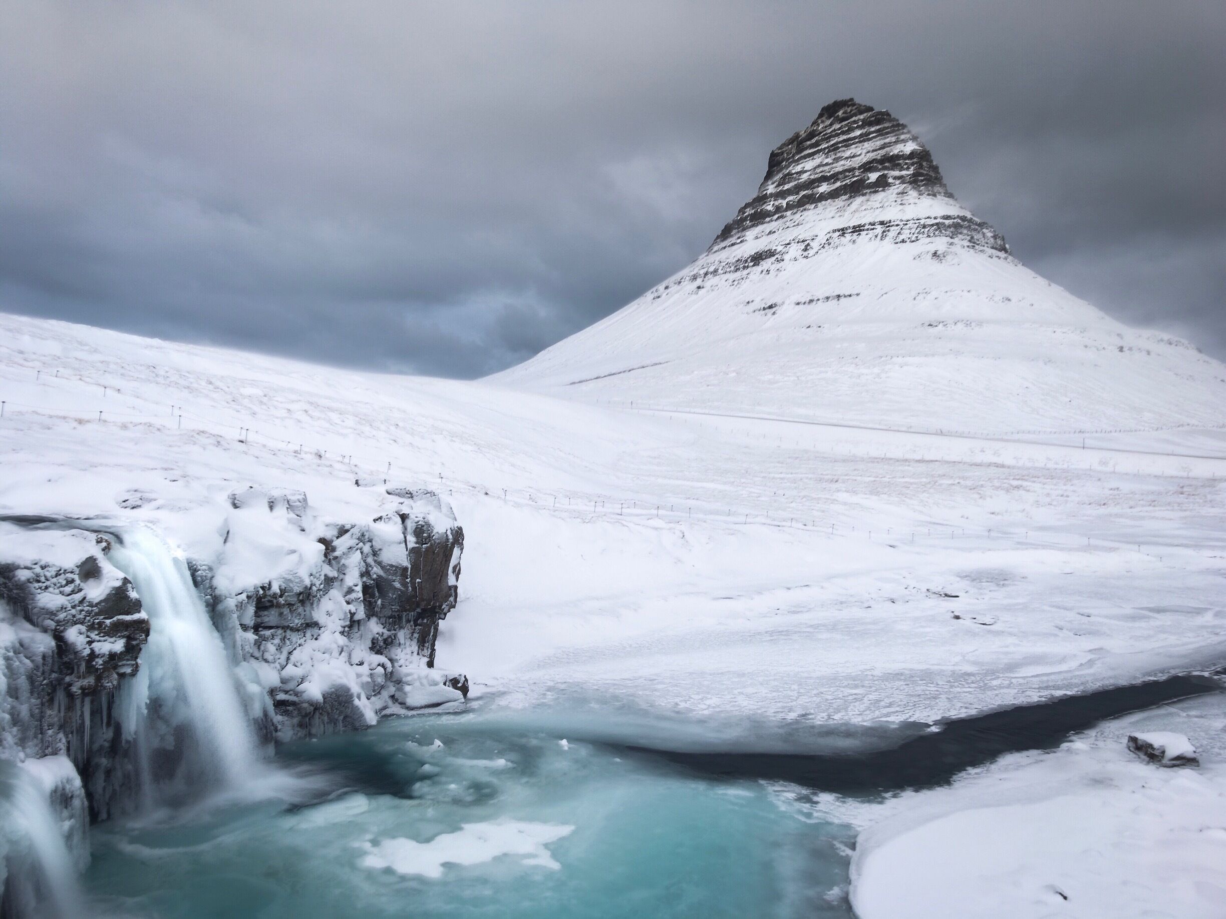 The famous Kirkjufell mountain. Taken with an iPhone on a tripod in extremely windy conditions!
It does get crowded here as it's become a very popular location. It's worth the walk around and over the bridge to get to the famous view. Wait there a while, don't rush to take a photo and you'll be rewarded with a break in the crowds