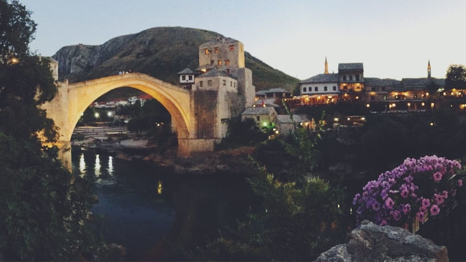 Stari Most (old bridge) in Mostar, Bosnia was built by the Ottomans in the 16th century. It stood for 427 years before it was destroyed during the Croat-Bosnian War in 1993 and was rebuilt in 2004. A beautiful feat of engineering and a sobering icon of post-war resilience, the bridge is free to visit and walk across, and connects two sides of Mostar's lively Old Town. Tip: visit early in the AM (before 8) for a peaceful, crowdless experience. Stop to linger over a pastry and Bosnian coffee at one of the many Pekaras along the way. Don't miss! #StariMost #bridge #OldCity #Mostar #Bosnia #historic #medieval