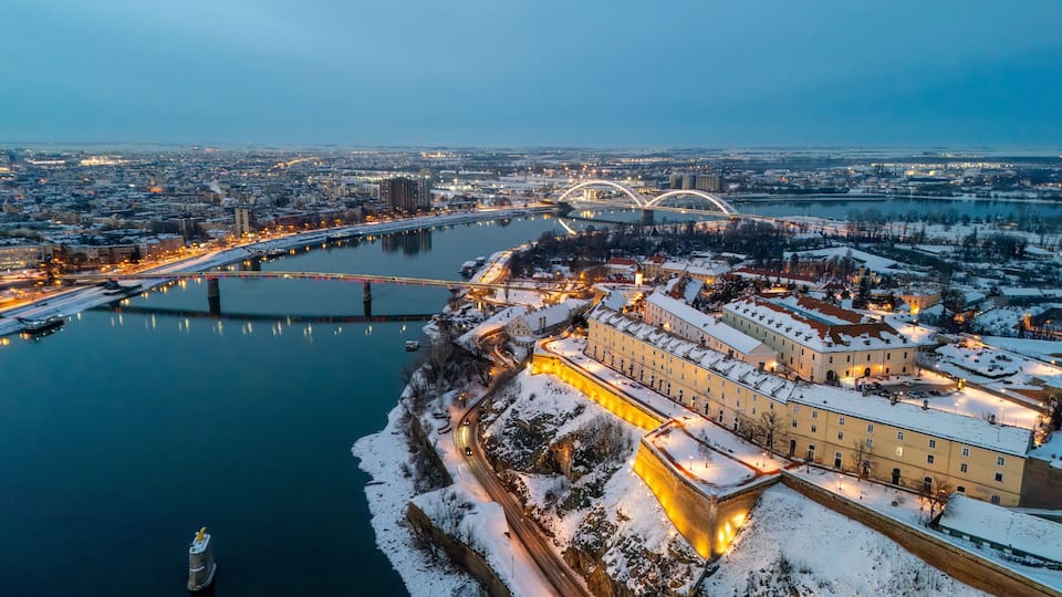 Aerial Night View of Illuminated Bridges over the Danube River in Winter, Novi Sad, Serbia