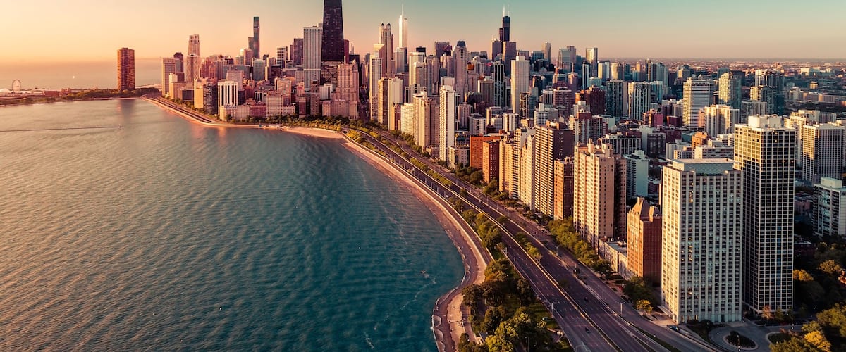 Chicago skyline aerial view with light effect applied. Sunrise above downtown buildings and Lake Michigan