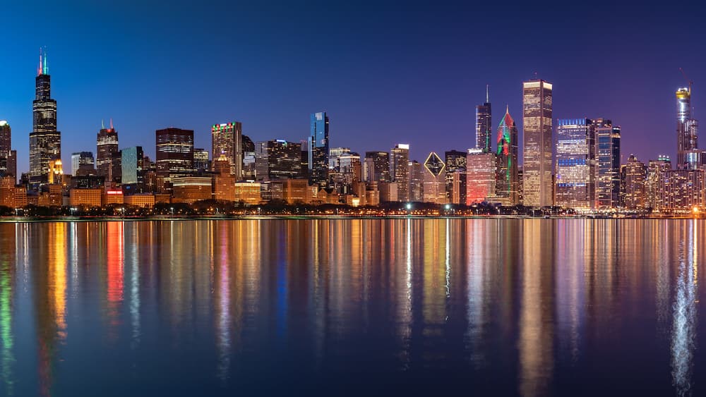 Chicago Skyline Cityscape at night with lake in front and blue sky with cloud, Chicago, United state.