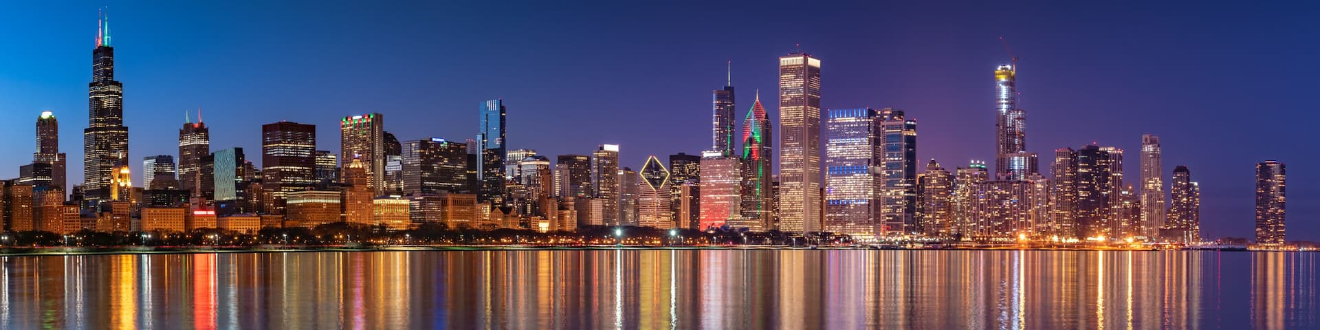 Chicago Skyline Cityscape at night with lake in front and blue sky with cloud, Chicago, United state.