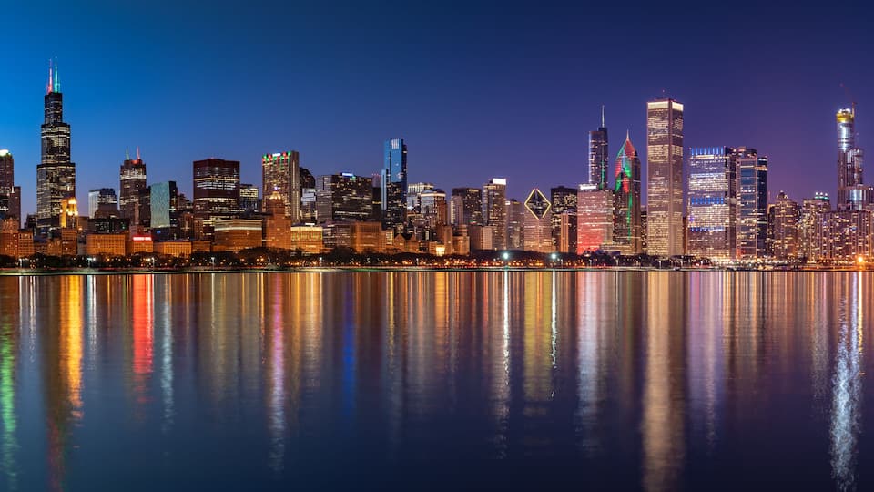 Chicago Skyline Cityscape at night with lake in front and blue sky with cloud, Chicago, United state.