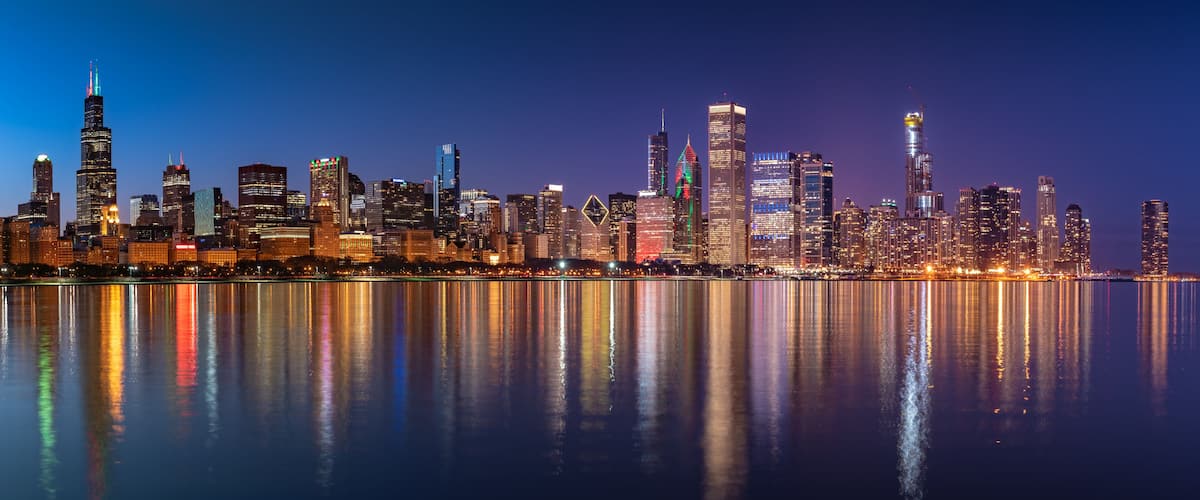 Chicago Skyline Cityscape at night with lake in front and blue sky with cloud, Chicago, United state.