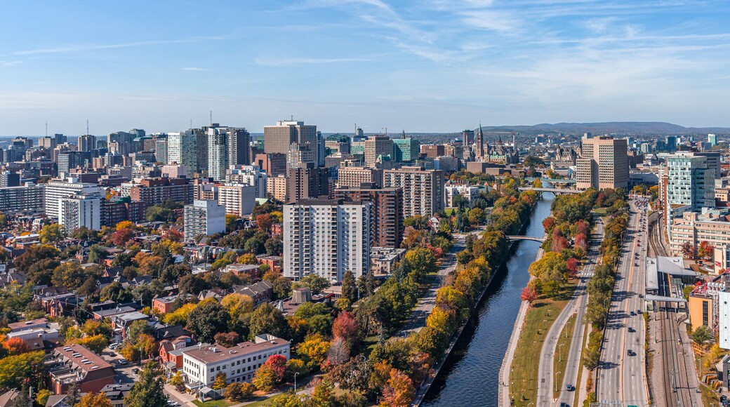 Stunning aerial view of downtown Ottawa, Ontario, Canada, with the Rideau Canal lined with vibrant autumn foliage, Gatineau Hills behind, capturing the beauty of fall in the capital (October 2025)