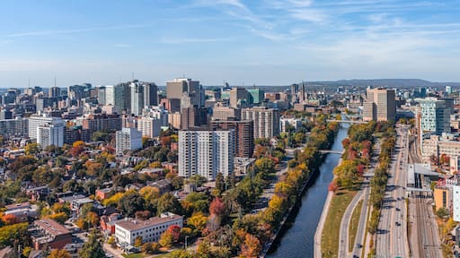 Stunning aerial view of downtown Ottawa, Ontario, Canada, with the Rideau Canal lined with vibrant autumn foliage, Gatineau Hills behind, capturing the beauty of fall in the capital (October 2025)