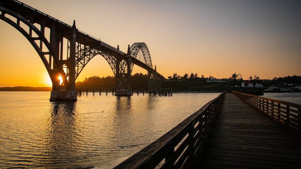A bridge at sunset with the sun setting behind it.
