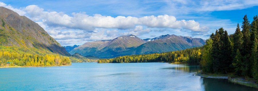 A mountain lake surrounded by forest and mountains.