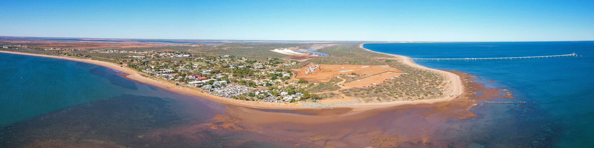 Aerial view of beadon bay at sunset with onslow sunset beach and onslow salt loading jetty, onslow, western australia.