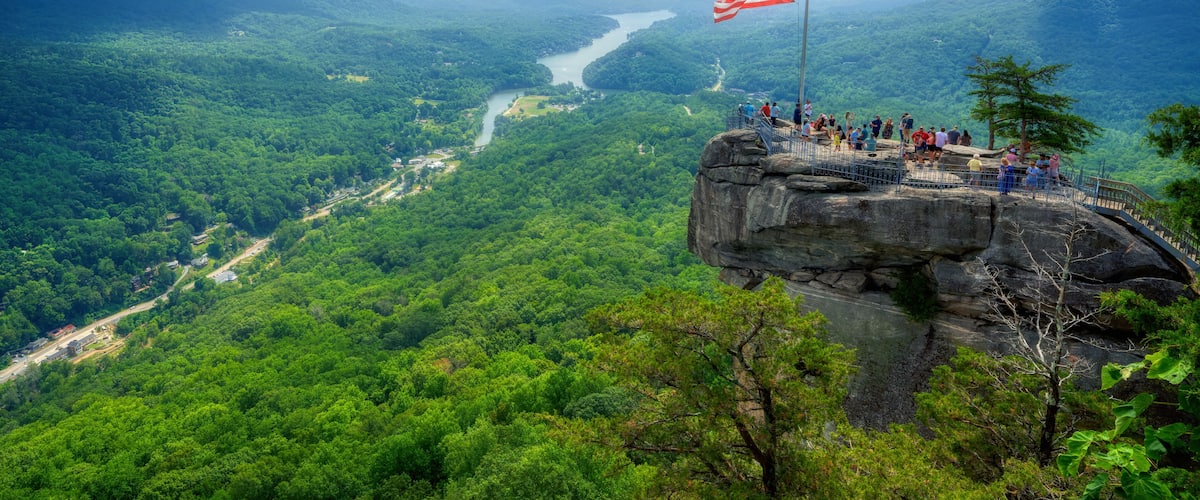 A beautiful scenic view of Chimney Rock and Lake Lure down below in the Hickory Nut Gorge in North Carolina in HDR.