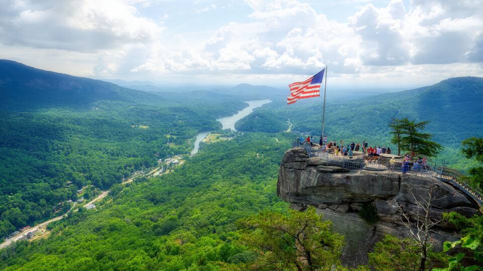 A beautiful scenic view of Chimney Rock and Lake Lure down below in the Hickory Nut Gorge in North Carolina in HDR.
