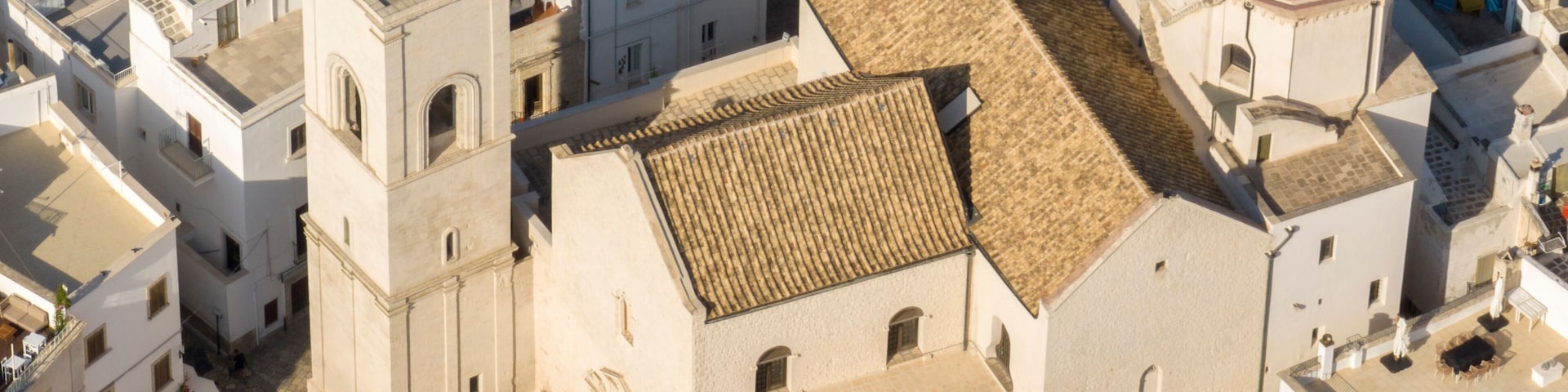 Aerial view of the Mother Church of Santa Maria Assunta located in Polignano a Mare, in the province of Bari, Puglia, Italy. It is the church of the historic center of the town.