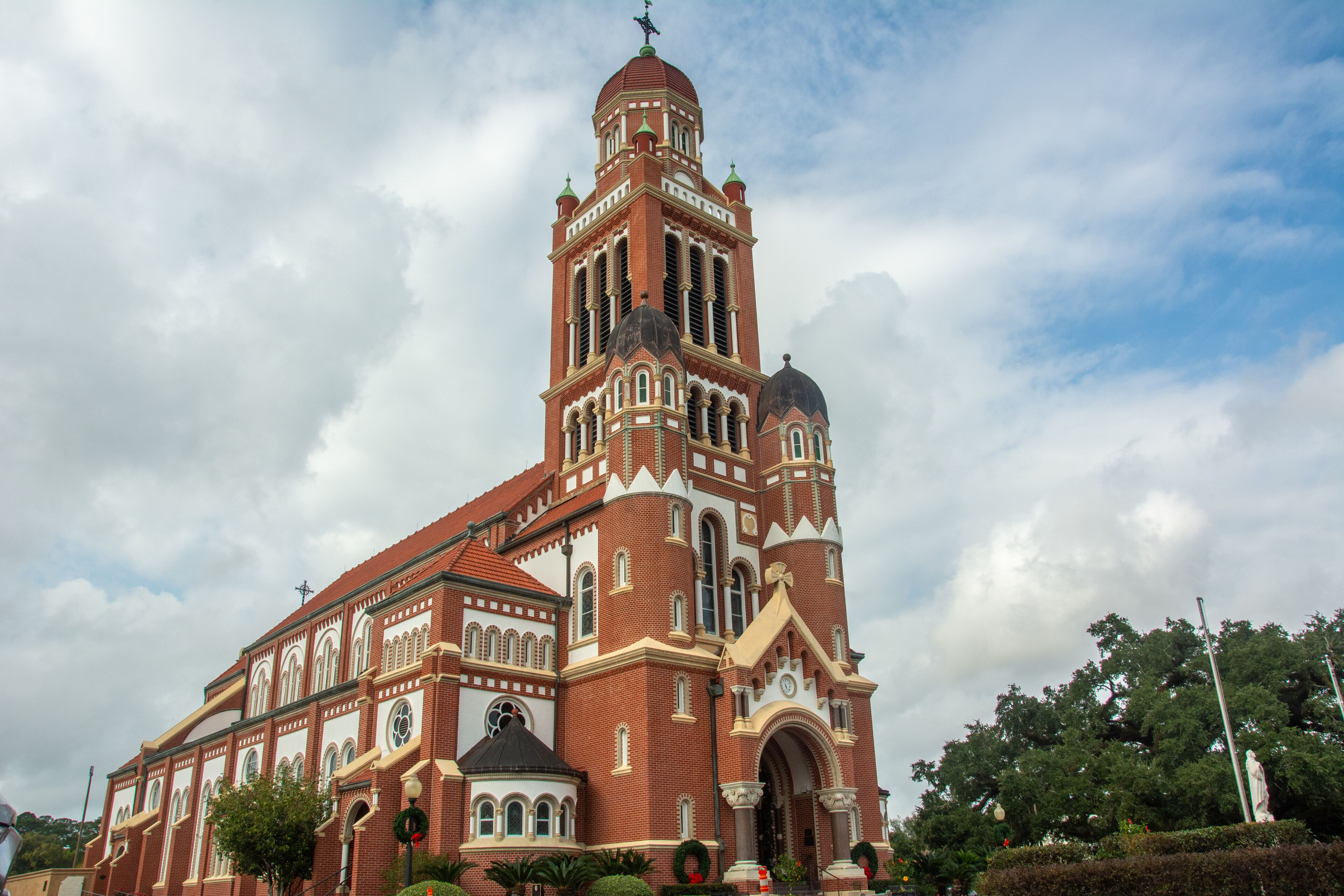 A large, historic church with a tall bell tower and multiple domes.