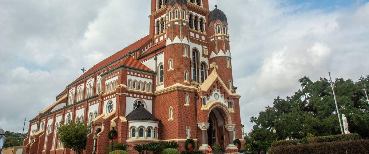 A large, historic church with a tall bell tower and multiple domes.