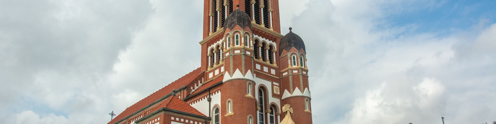 A large, historic church with a tall bell tower and multiple domes.