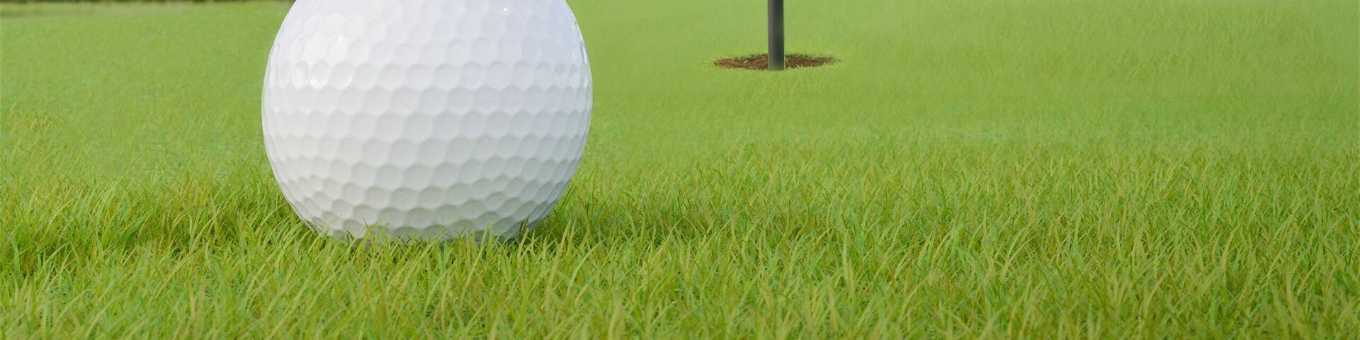 Tennessee flag on golf course putting green with a ball near the hole