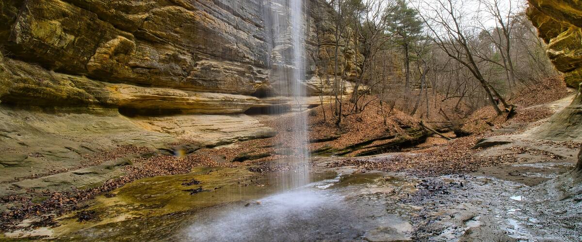 Early Spring landscape looking out from behind the LaSalle Canyon waterfall at Starved Rock State Park near Oglesby, Illinois.