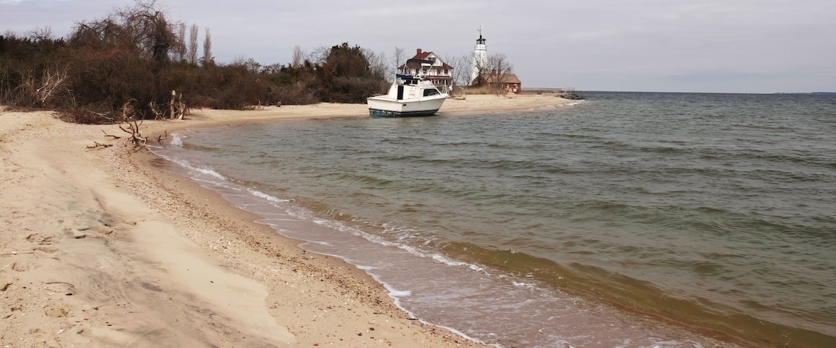 a beached boat at cove point lighthouse in lusby, maryland