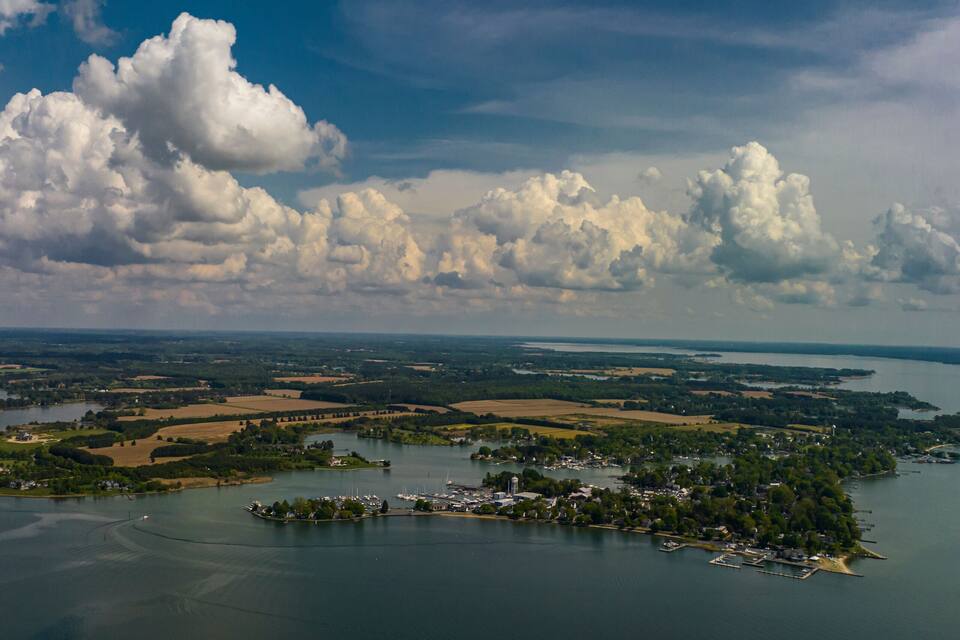 An aerial view of a lake surrounded by farmland and small towns.