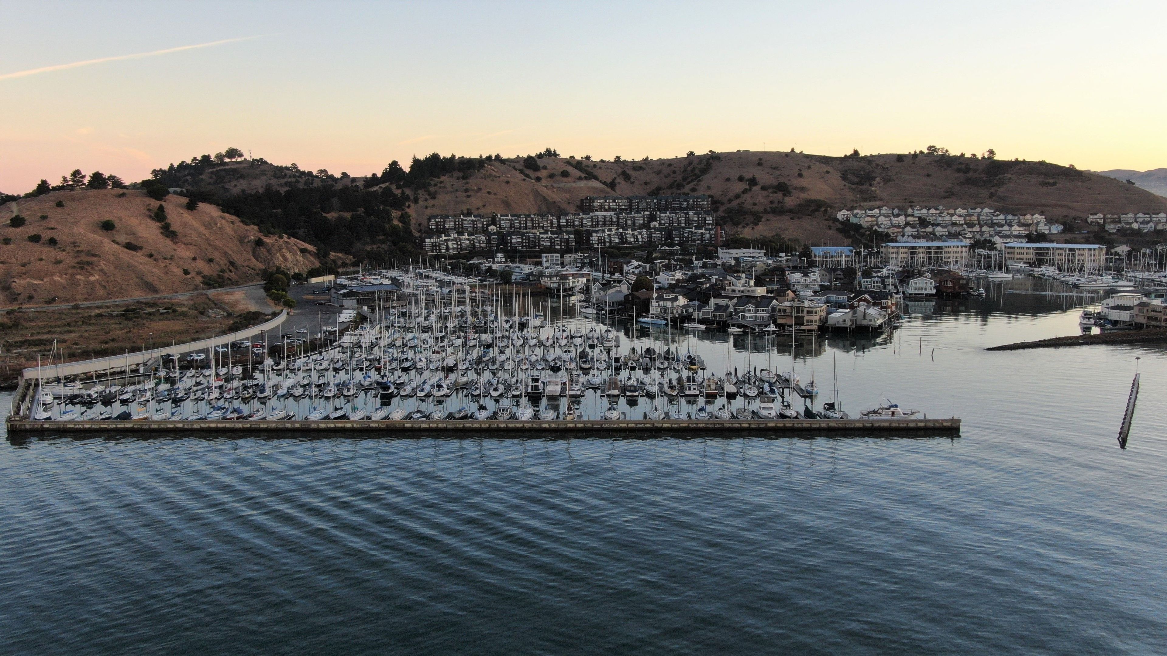 Drone shot of boats marina on the shore of Lake Oroville at sunset in California