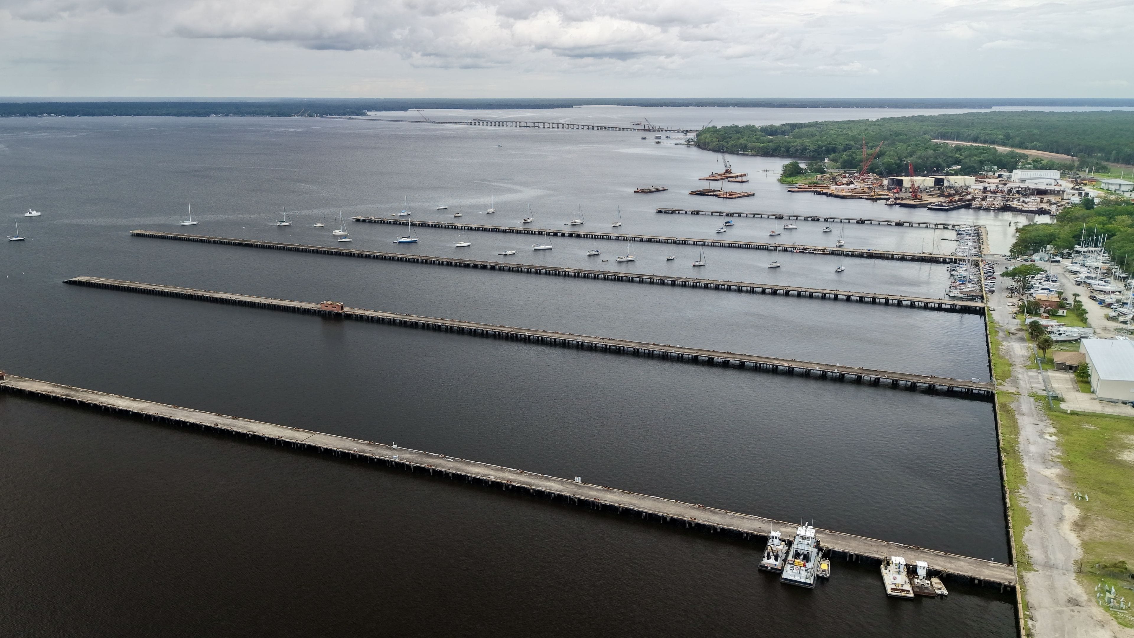 A large body of water with multiple piers and boats.