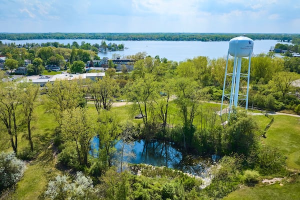 Aerial View of Suburban Landscape with Water Tower and Lake in Warsaw