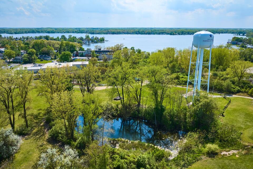 A water tower, a lake, and a residential area with houses and trees.