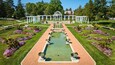 Low aerial pools of water with flowers and white pergola and trellises at Lakeside Park