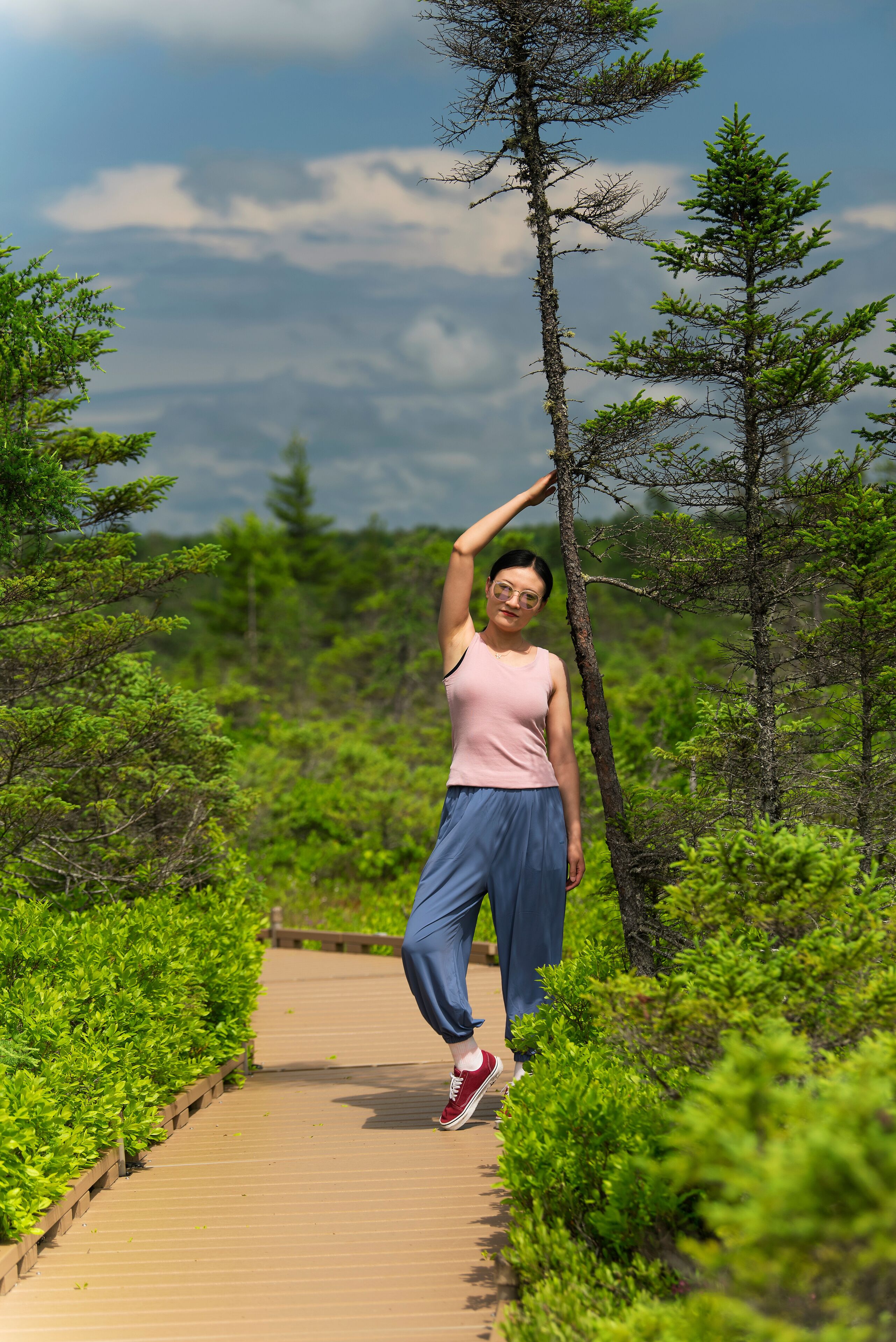 A smiling chinese woman on the orono bog boardwalk in bangor Maine