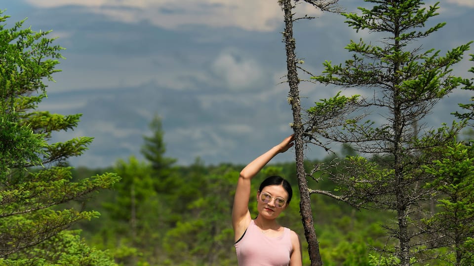 A smiling chinese woman on the orono bog boardwalk in bangor Maine