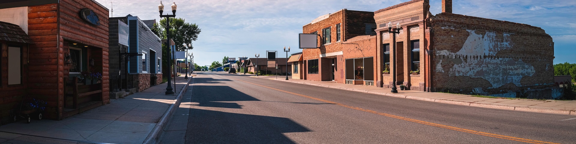 Old western cityscape and skyline at cloudy sunset. Quiet streets and rustic buildings in the historic downtown of Ortonville, Minnesota, USA.